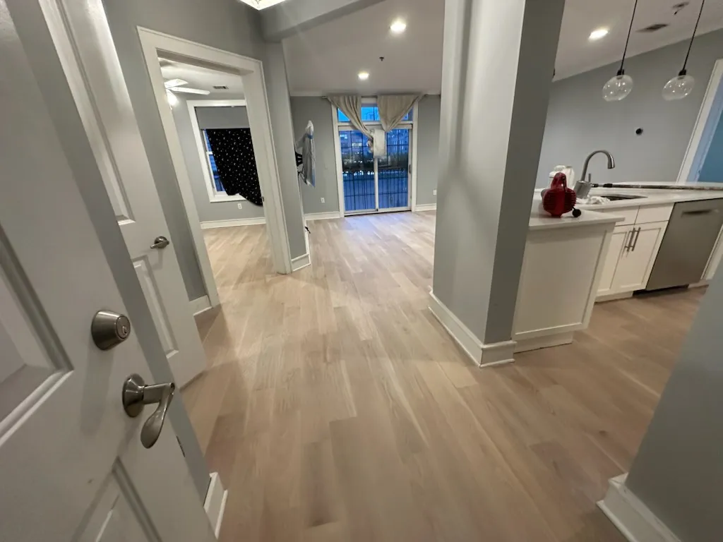 Finished apartment entry and kitchen with new light oak flooring