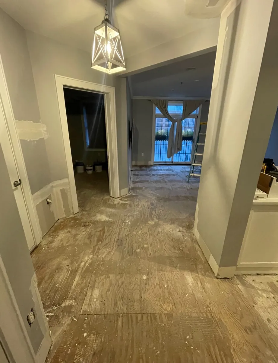 Apartment entry hallway down to the subfloor before new flooring