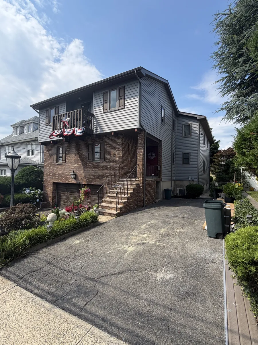 Two-story home with new gray siding installed by Metro Home Improvement